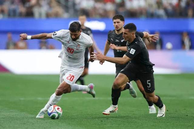 Iran and New Zealand players competing during a World Cup Group G match.