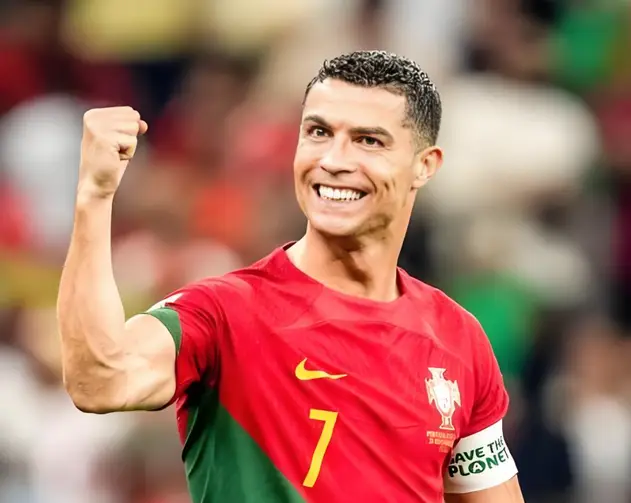 Cristiano Ronaldo celebrating while wearing Portugal's red kit.